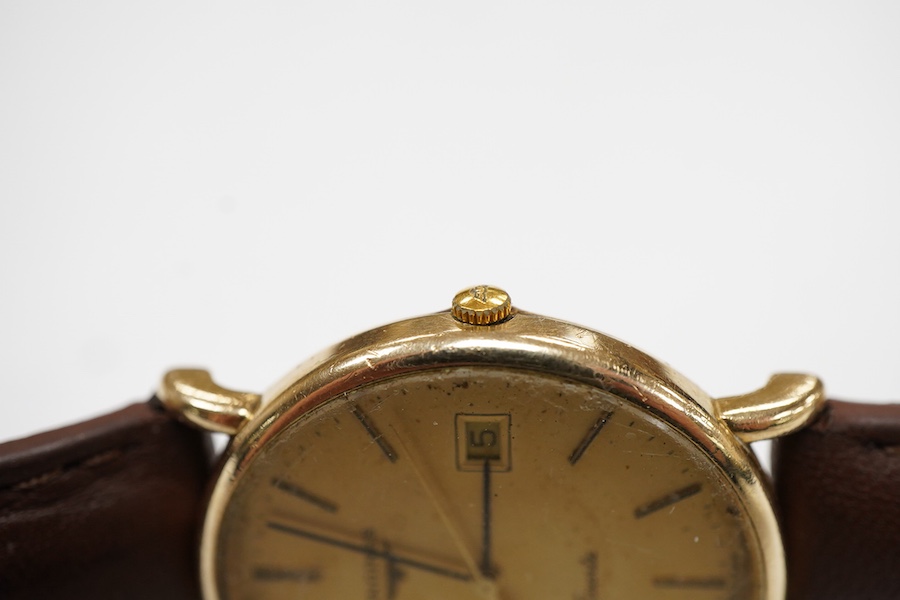 A gentleman's late 20th century Longines 9ct gold quartz wrist watch, with baton numerals and date aperture, the case back with engraved monogram, case diameter 32mm, on an associated leather strap, no box or papers.